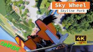 Onride-Perspektive der Sky Wheel Achterbahn im Skyline Park, mit Blick auf die orangefarbenen Sitze und die vertikale Strecke über dem Parkgelände.